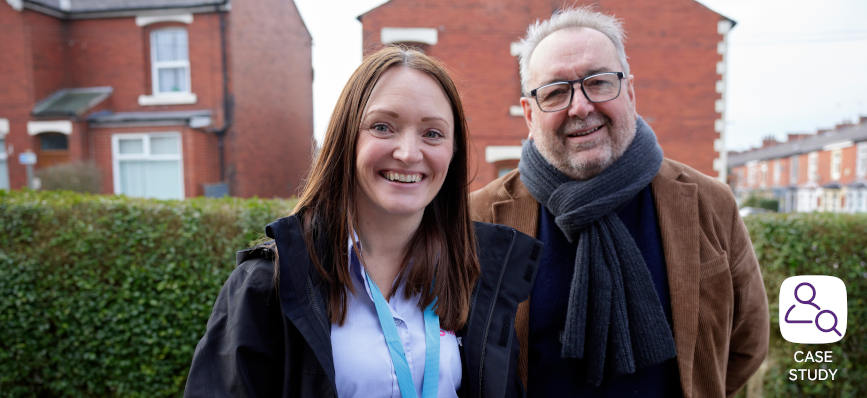 two members of Housing Group standing outdoors smiling  