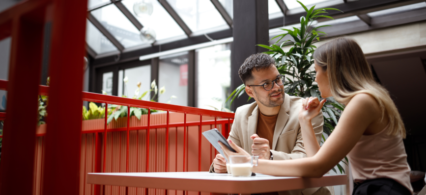 This image shows two people looking at a computer. 