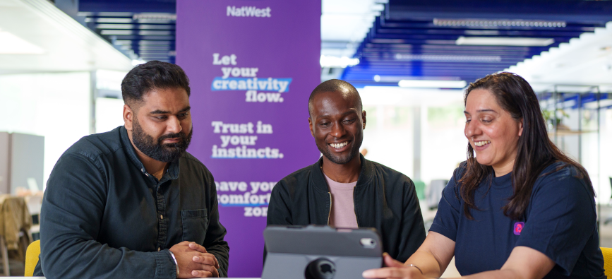 This image shows three people looking at a screen in our Birmingham Accelerator Hub  