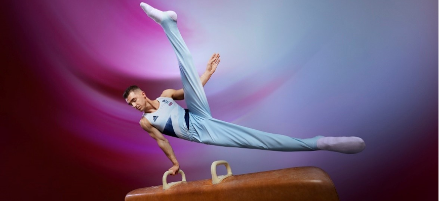 An action photograph of Max Whitlock performing a gymnastic routine
