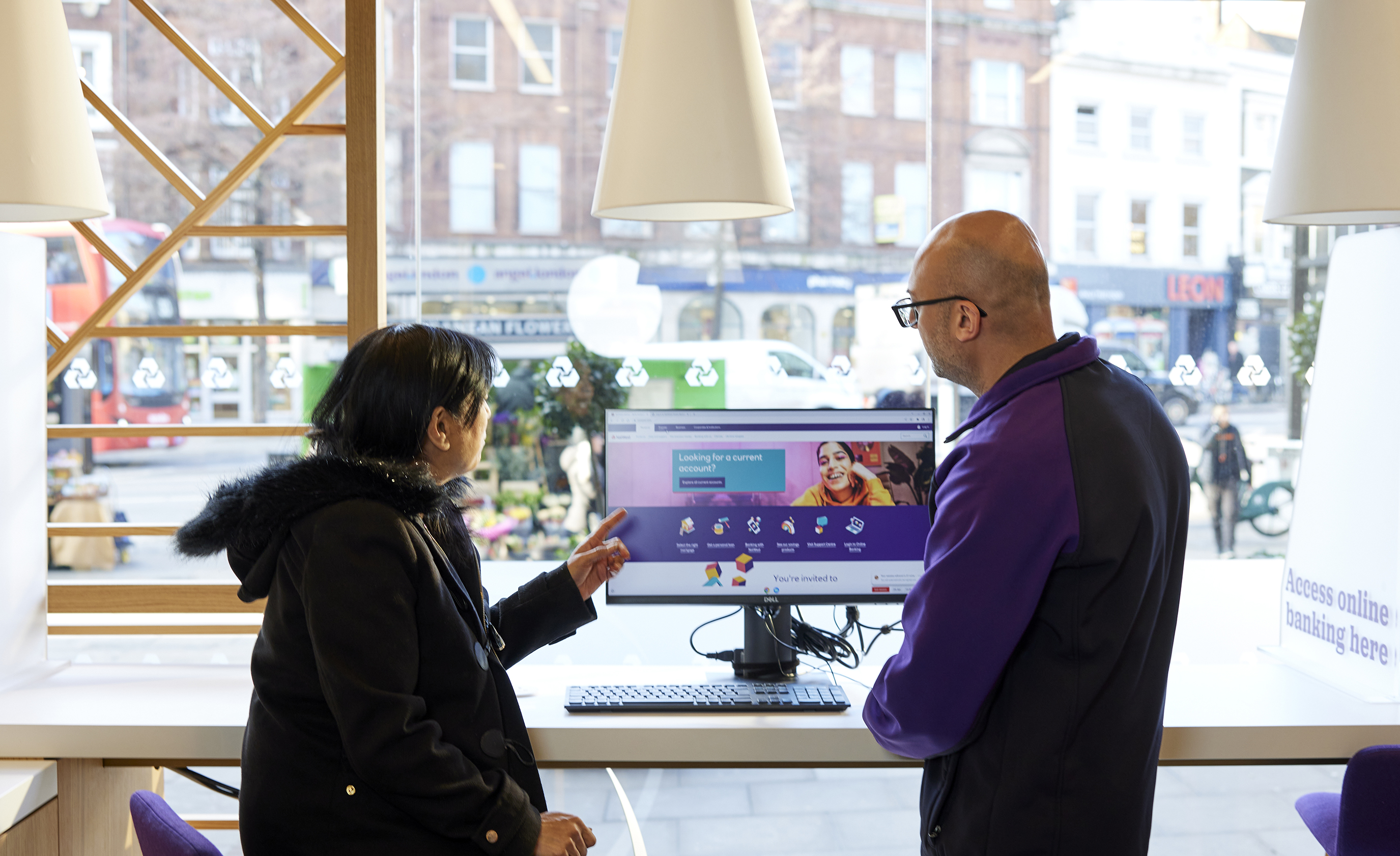a customer being supported with digital activity in a branch