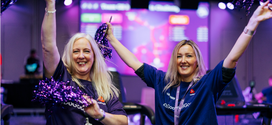 two of our colleagues wearing NatWest t-shirts with their hands in the air