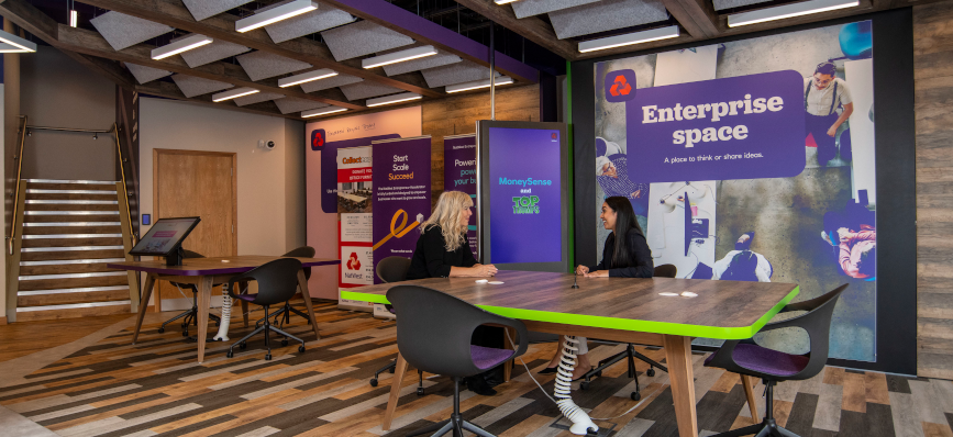 Image of two people at a table in an office space