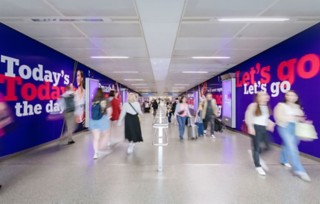 A photo shot at London St Pancras station in a passenger walkway, posters on both sides of the walkway show NatWest Team GB advertisements, with ‘Today’s the day’ and ‘Let’s go’ featuring prominently